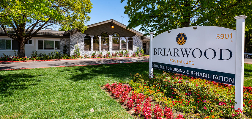 briarwood-848x400-7 Lawn, flowers, sign, and front of Briarwood Post Acute