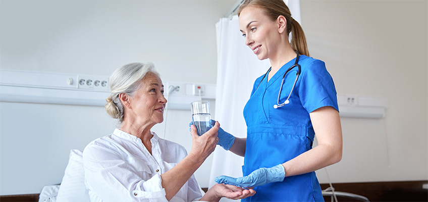plum-848x400-103 Nurse leaning down to speak with a patient