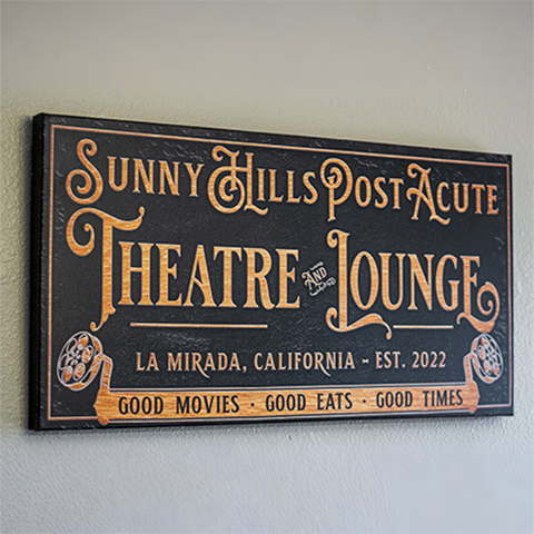 An outdoor sign reading "Sunny Hills Post Acute Theatre and Lounge"