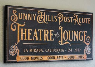 An outdoor sign reading "Sunny Hills Post Acute Theatre and Lounge"