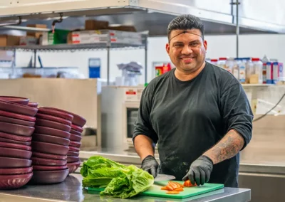 A staff member prepares a meal in the kitchen