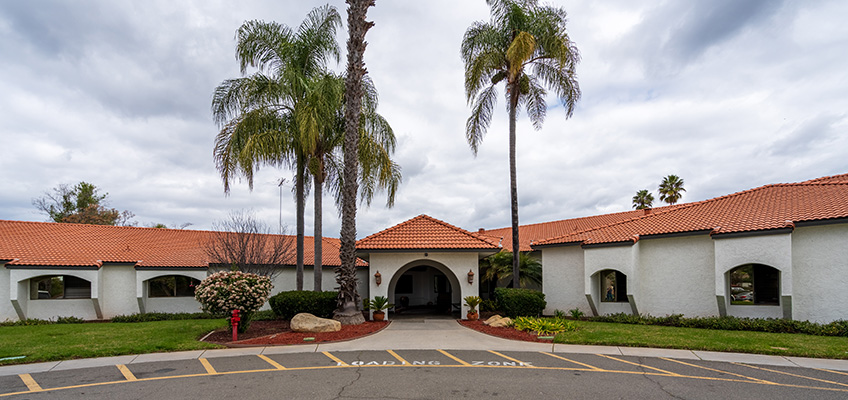 Ocean View front of facility with palm trees and flagpole