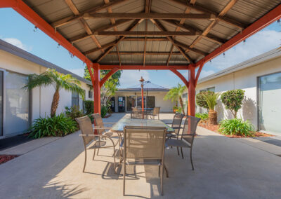 A table and chairs under a gazebo in the courtyard of Cottage Crest