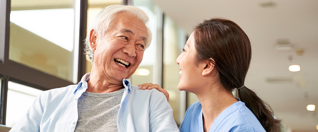 yolo-1080x450-86 An elderly man smiling with a nurse