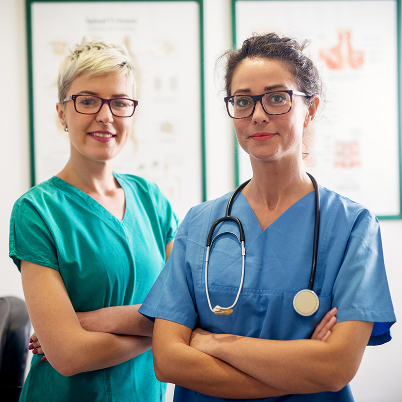 Two nurses standing next to each other