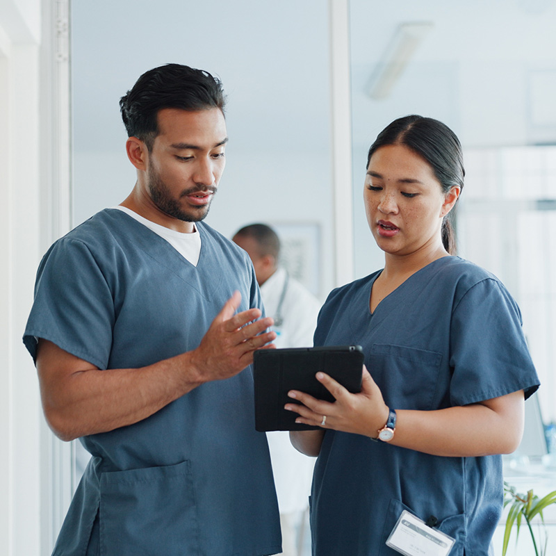 Two nurses looking at a tablet
