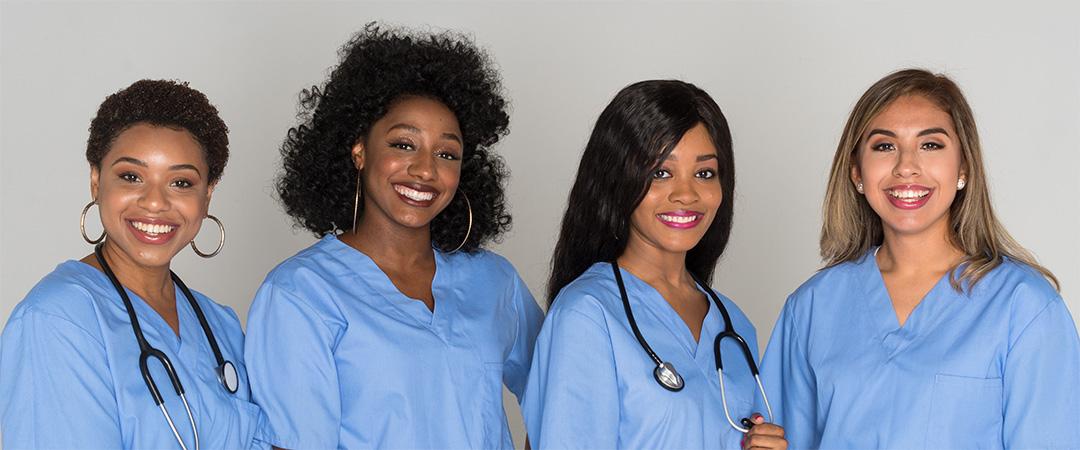 Four nurses smiling