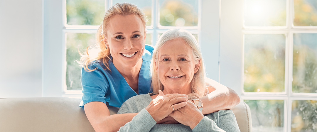 A nurse smiling with an elderly woman