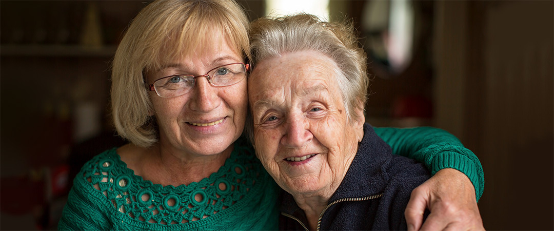 Mother and daughter sitting closely and embracing