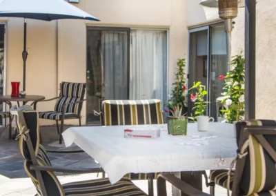 Outside dining with tables and chairs at the Meadows on Sunset facility