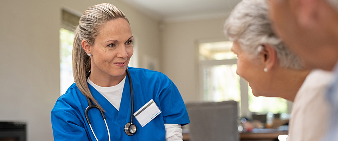 Physician talking to two seniors